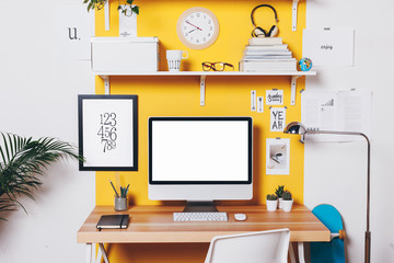 Modern creative workspace on yellow wall. - obrazy, fototapety, plakaty
