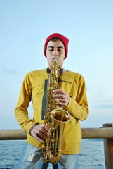 modern musician posing with his saxophone