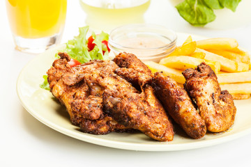 Chicken wings with fries french and spicy sauce