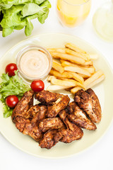 Chicken wings with fries french and spicy sauce