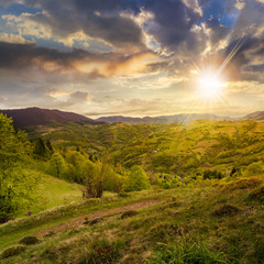 field near home in mountains at sunset