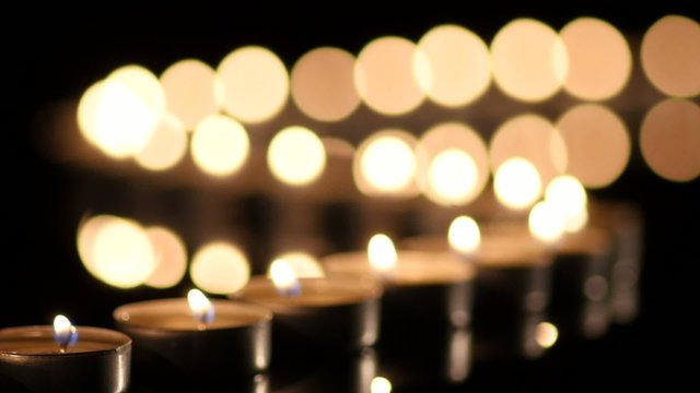 Many Candles light on black background