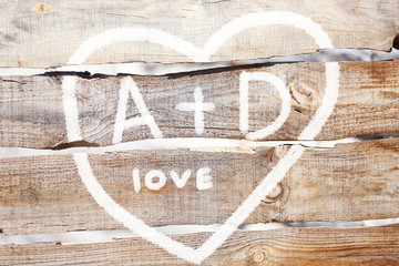 Love concept. Drawing on wooden wall background