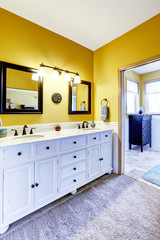 Beautiful  vanity cabinet in bright yellow bathroom