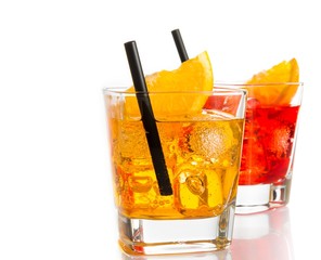 red and yellow cocktail with orange slice on top and straw
