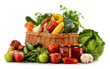 Wicker  basket with groceries isolated on white