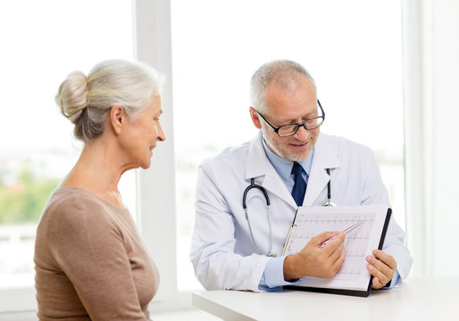 smiling senior woman and doctor meeting