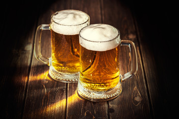 mug of beer on wooden background