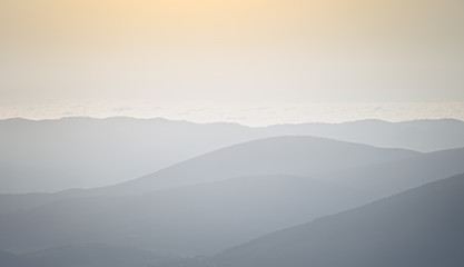 Silhouettes of mountain slopes in the haze