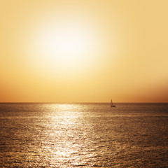 Boat sailing on the sea at sunset