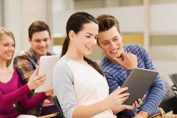 group of smiling students with tablet pc