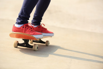 skateboarding woman legs at skatepark 