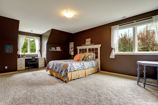 Master bedroom in dark brown color with office area