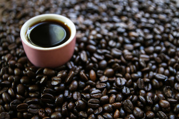 coffee cup with burlap sack of coffee beans and scoop