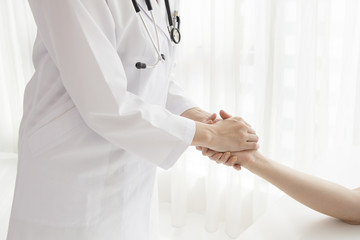 Doctor who holds the patient's hand