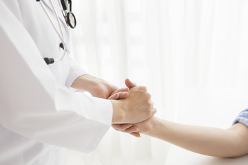 Woman doctor hold hand
