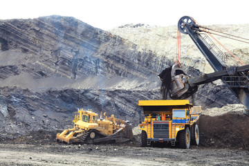 Haul Trucks being loaded with ore.