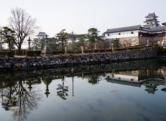 Fototapeta premium Entrance to Imabari castle - bridge reflects in water
