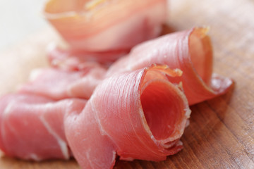 dried jamon slices on wood table