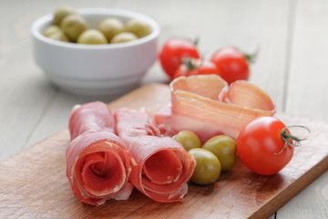 dried jamon slices on wood table