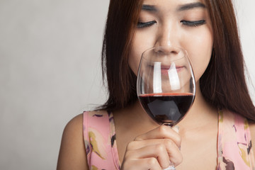 Beautiful Asian woman smell aroma of  red wine