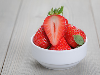 fresh ripe strawberryes in a simple white bowl