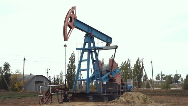 Work of oil pump jack on a oil field.