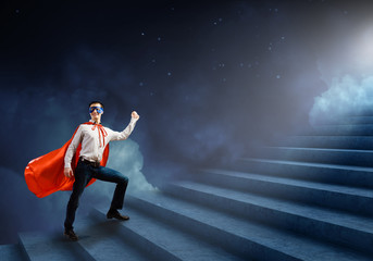 Fototapeta premium Superman on ladder