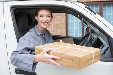 Delivery driver smiling at camera in her van