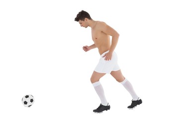 Full length of shirtless football player playing