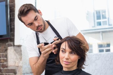 Handsome hair stylist with client