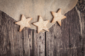 Fototapeta na wymiar Sweet cookies in star shape on rustic wood