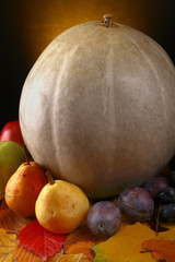 Pumpkin with fruits over leaves