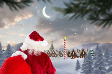 Composite image of santa claus carrying sack