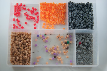 Colorful toy beads in a plastic box