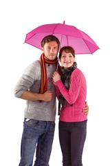 Couple standing underneath an umbrella