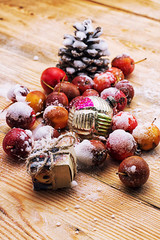 snow-covered fruits of dwarf apples and Christmas decorations