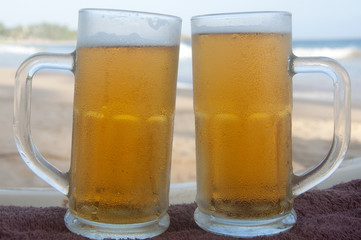 Chilled beer on a sunny day by the beach