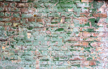 Background of old vintage dirty brick wall with peeling plaster,