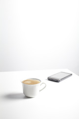 Coffee cup and mobile phone