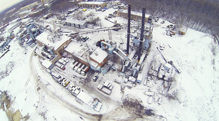 Industrial area with machines and crane at winter day.