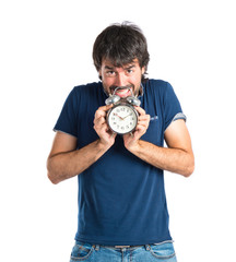 Man holding a clock over white background