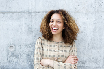 Cheerful young woman laughing outdoors