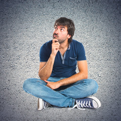 Man thinking over textured background
