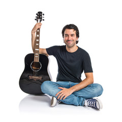 Handsome man with guitar over white background