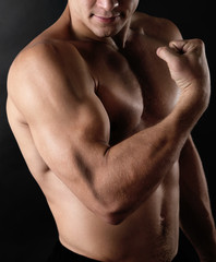 Fototapeta na wymiar Sexy muscular man on dark background
