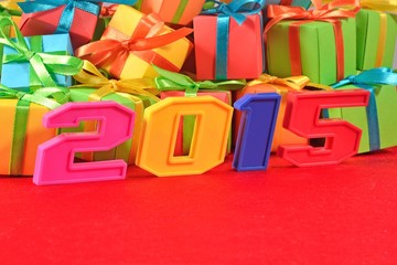 Fototapeta na wymiar 2015 year colorful figures on the background of gifts