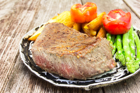 grilled fillet steak served with tomatoes and roast vegetables o