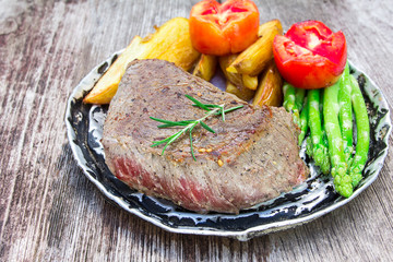 thick juicy portions of grilled fillet steak served with tomatoe