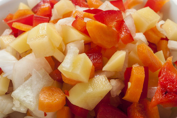 Raw vegetable cut in wooden background close up